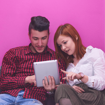 two people looking at a tablet